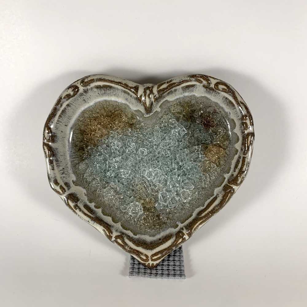 Beautiful heart-shaped trinket dishes made of pottery with fused glass